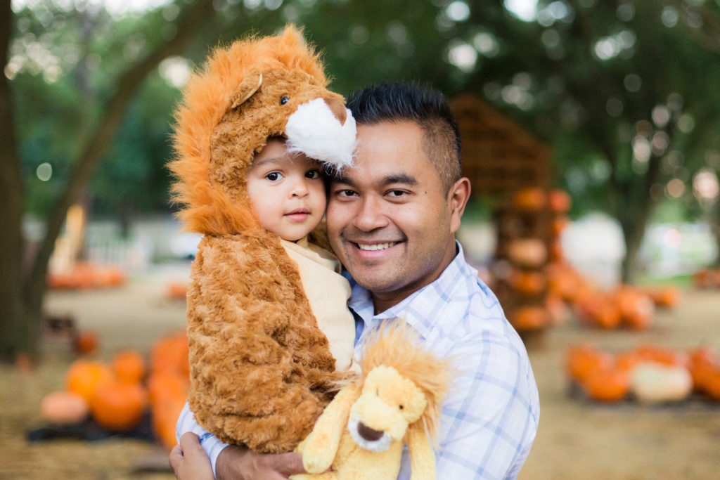Toddler Boy in Lion Halloween Costume in a Pumpkin Patch